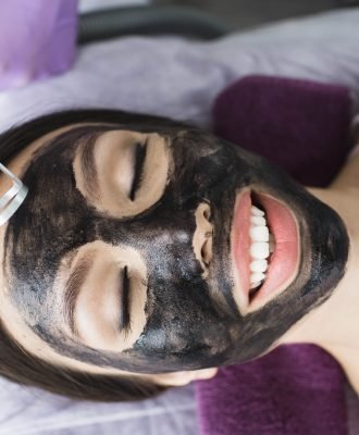 Cute Korean woman gets a face peeling procedure in a beauty salon. Skin care